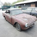 A 1965 maroon Sunbeam Alpine two seater sports car, in barn find condition for restoration,
