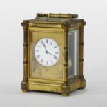 A large 19th century gilt brass cased carriage clock, the white enamel dial with Roman hours,