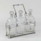 An Edwardian silver plated tantalus, fitted with three glass decanters,