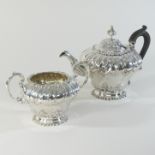 An Edwardian silver teapot and matching sugar bowl, of circular pedestal shape,