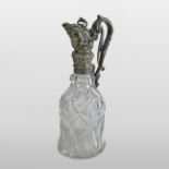 A 19th century continental cut glass claret jug, with ornate silver plated mounts,