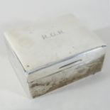 An early 20th century silver table cigarette box, of plain rectangular shape, engraved monogram R.G.