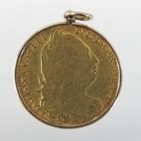 A George III gold guinea, 1775, mounted, obverse with fourth laureate head,