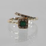 A 14 carat gold emerald and diamond asymmetric ring