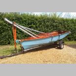 A Puffin Pacer dinghy, 390 x 135cm, with trailer and launcher, sail and sail cover, two fenders,