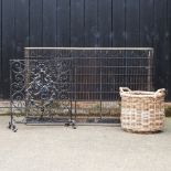 A brass and iron fender, 129cm, together with a spark guard, log basket,