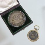A Victorian memorial locket, inset with a lock of hair and dated 1869,