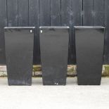 A set of three large black garden pots,