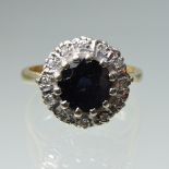 An 18 carat gold, sapphire and diamond cluster ring,