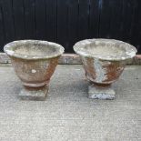 A pair of reconstituted stone garden pots,