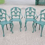 A set of four green painted metal garden chairs