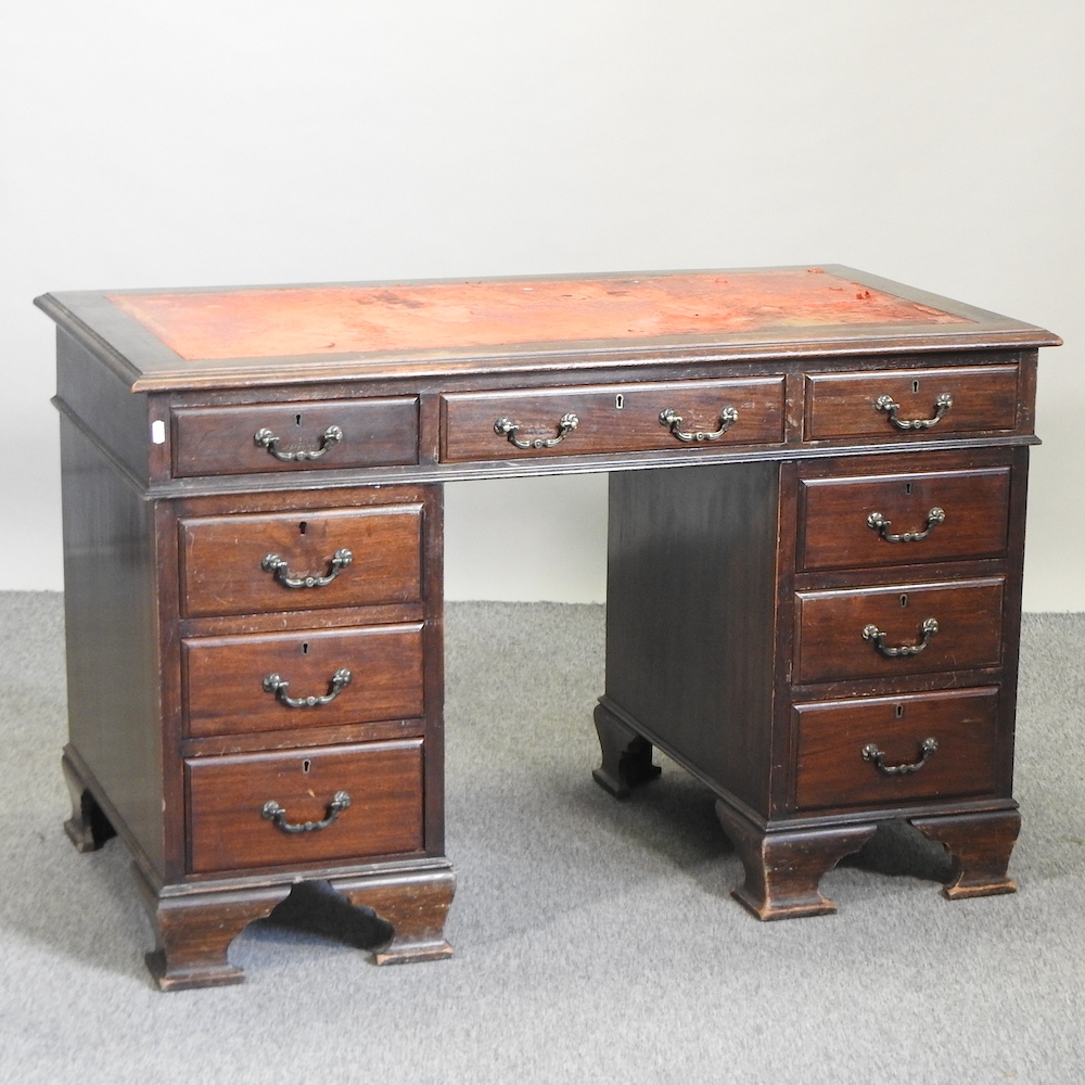 An Edwardian mahogany pedestal desk, with a leather inset top,