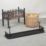 A cast iron fire grate, 67cm, together with a fender and a wicker log basket,