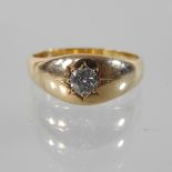 An 18 carat gold gypsy ring, set with a single diamond, approx 0.