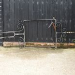 A large black painted wrought iron sign frame,