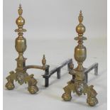 A pair of early 20th century large and ornate brass andirons,