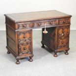 An 18th century style pedestal desk, with geometric moulded decoration,