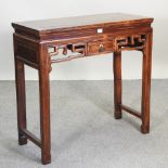 A Chinese side table, the carved frieze containing a single drawer,