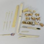 A collection of early 20th century bone and ivory items, to include a page turner, pen,