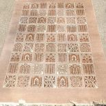 A large woollen carpet, with all over geometric design, on a beige ground,