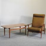 A 1960's teak armchair, together with a teak coffee table,