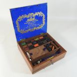 A mahogany artist's box, by Winsor and Newton, containing paints,