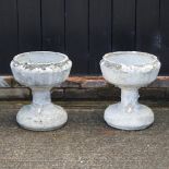 A pair of reconstituted stone planters,