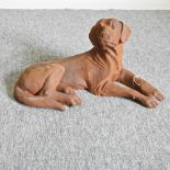 A rusted metal model resting dog,