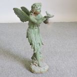 A painted metal model of a fairy holding a bird,