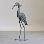 A painted metal model of a heron,