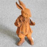 A rusted cast iron garden figure of Mr Rabbit,