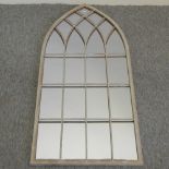 A gothic style metal framed arched garden wall mirror,
