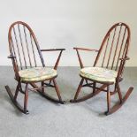 A pair of 1970's Ercol dark elm spindle back rocking chairs