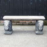 A reconstituted stone garden bench, on elephant supports,