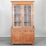 A pine dresser, with a glazed upper section,