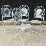 A set of four white painted metal folding garden chairs