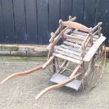 A wrought iron and wooden child's hand cart,