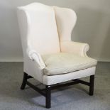 A Ralph Lauren cream upholstered wing armchair