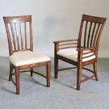 A set of eight modern hardwood dining chairs, with cream upholstered seats,