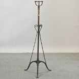 An early 20th century brass floor standing oil lamp, in the manner of W A S Benson,