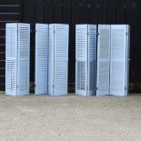 A pair of blue painted three fold plantation blinds,