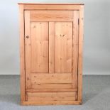 An early 20th century pitch pine hall cupboard,