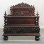 A 19th century continental heavily carved dark oak single bedstead,