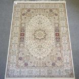 A Keshan style carpet, on a beige ground,