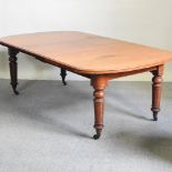 A 19th century walnut wind-out extending dining table, with an additional leaf,