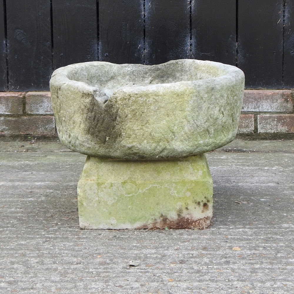 An antique carved stone planter, on stand,