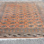 A Bokhara carpet, with five rows of medallions, on a red ground,