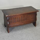 A 1920's oak coffer, with linen fold decoration,