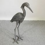 A painted metal figure of a heron,