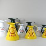 A set of three painted metal Shell advertising jugs,